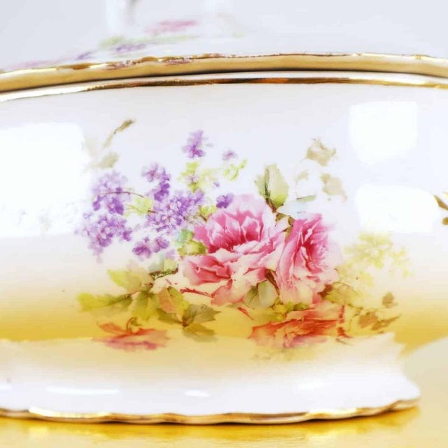 This elegant ginori tureen is a charming example of fine italian ceramics, decorated with delicate floral motifs in gold...