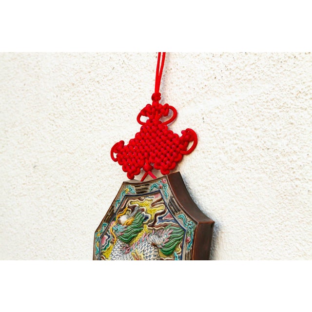 This substantial wall-hanging is centered by an octagonal majolica-style plaque, showcasing a Qilin—the mythical "Chinese...