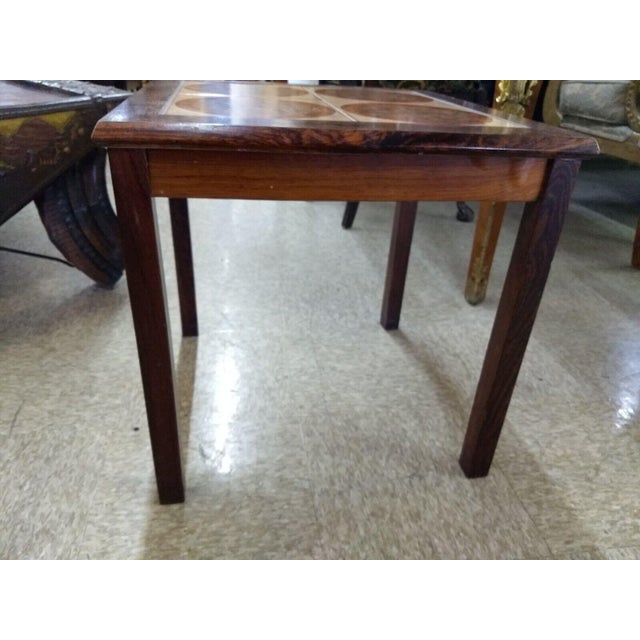 Danish Mid Century side or end table from the 1960's. The tiles are a stylish mid-century pattern in orange and brown. The...