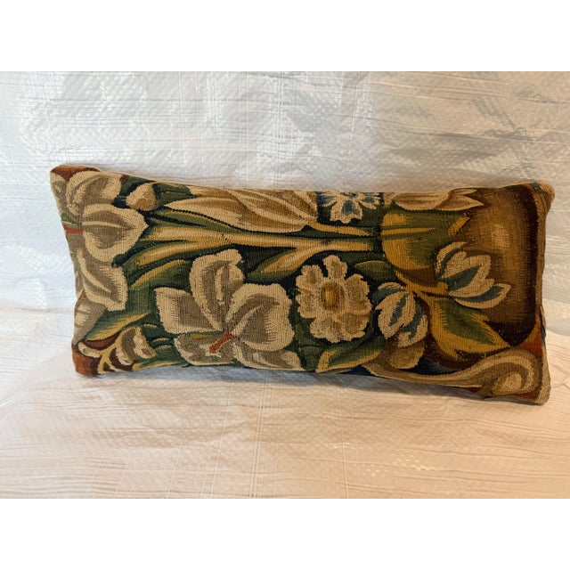An elegant decorative pillow crafted from an authentic 16th century Brussels tapestry fragment, featuring a graceful...