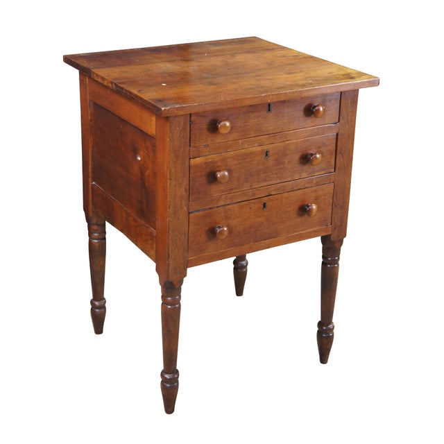 Antique Early American silver chest / console / stand. Made of cherry featuring three lockable drawers and long turned...
