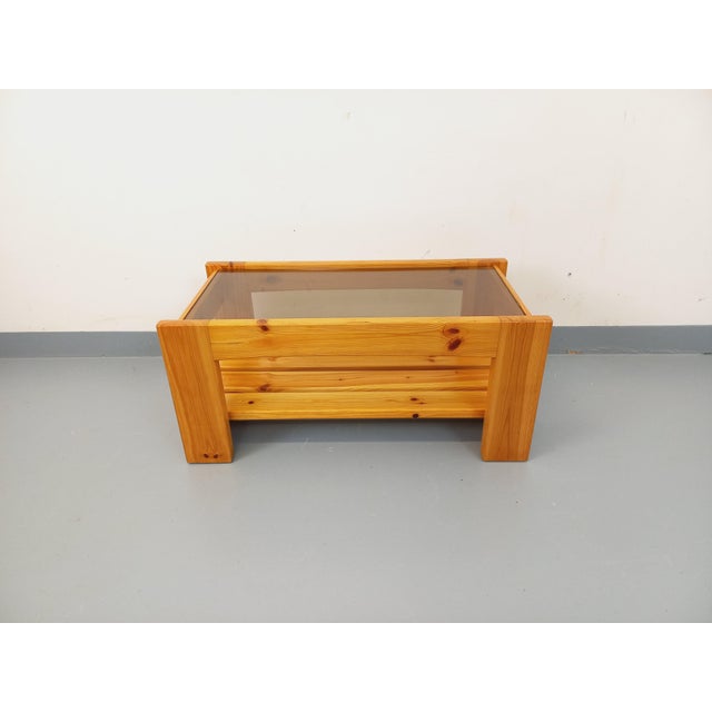 Vintage rectangular coffee table from the 1970s/80s, with a pine frame and slatted magazine rack top, and a rectangular...