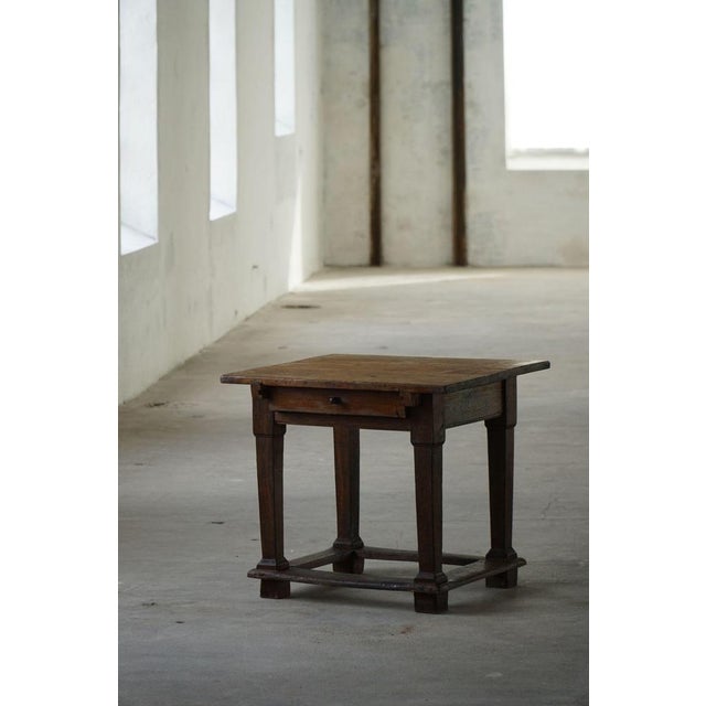 A charming early 18th-century side table crafted in solid oak from circa 1820. Featuring a rectangular top, a single...