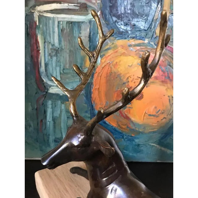 Beautiful bronze sculpture of a sitting deer.