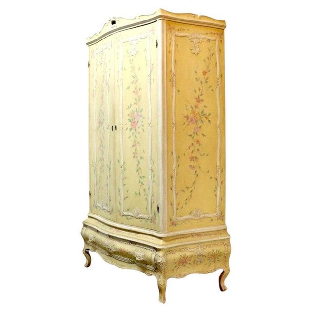 This vintage Niccolini Italia Rococo armoire, dating to approximately 1940, features a custom painted finish with delicate...