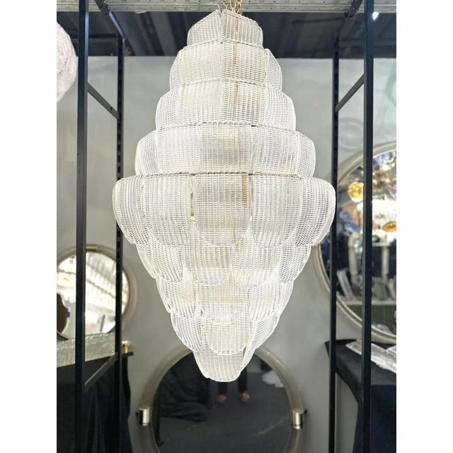 Luxury modern chandelier with sanded pink and amber ”petals” in murano glass . hand-made in murano glass , all made in...