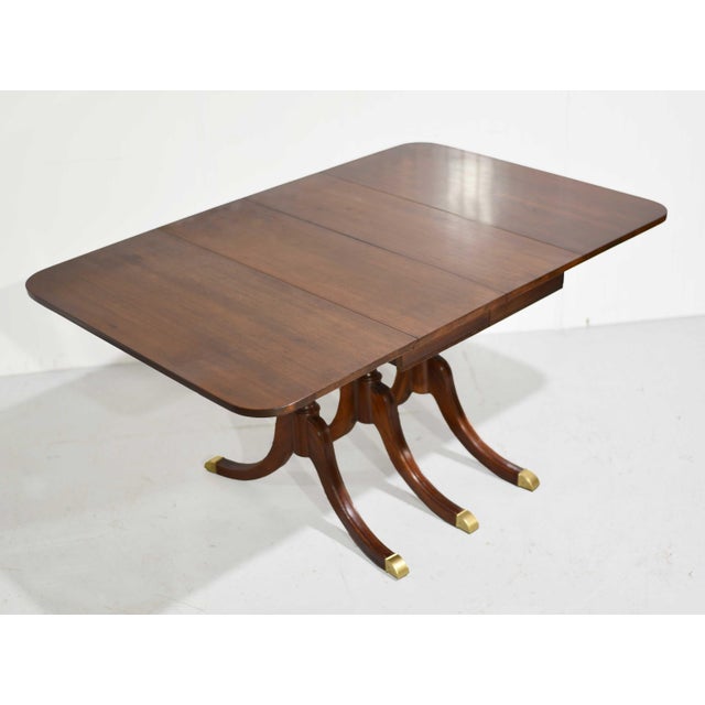 A polished, space-smart take on classic dining, this mahogany drop-leaf table blends Regency-inspired detail with mid...