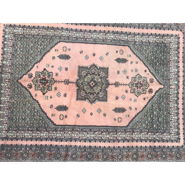 Beautiful midcentury Moroccan rug with a geometric design with central medallion and stylized flowers and a pink field...