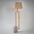 Floor lamp set on a rectangular white and grey marble base with an asymmetrically mounted brass frame. Dimensions without...