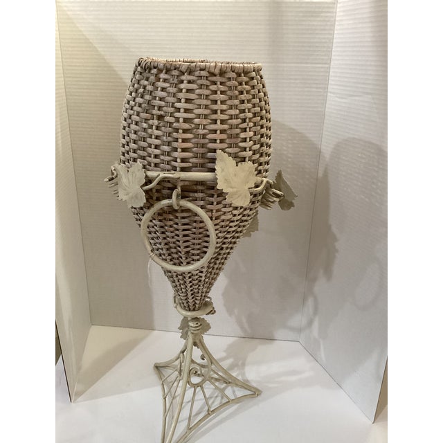 24” tall, 9” width, and top opening 6”. Vintage Victorian wicker vase/urn and wrought iron ivy plant stand. There is no...