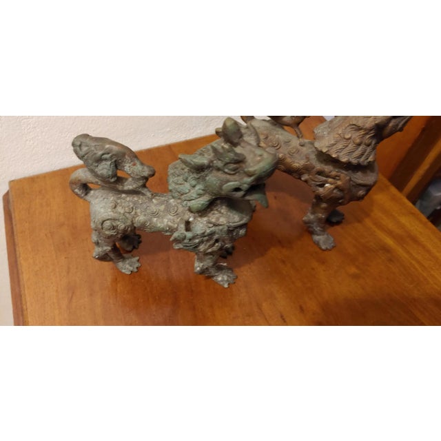 Awesome pair of heavy bronze Foo Chinese dogs. One has more patina than the other bit both are in Excellent condition....