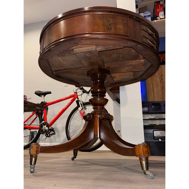 This elegant vintage drum table, crafted from rich mahogany, is a classic example of the traditional Federal or Georgian...