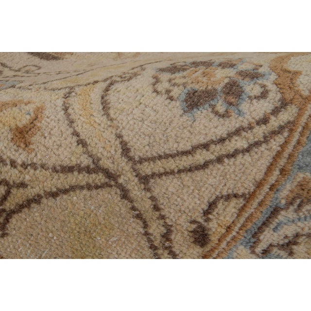 An early 20th century Persian Kashan antique carpet, the camel field with an allover trellis of palmettes, leafy vinery...