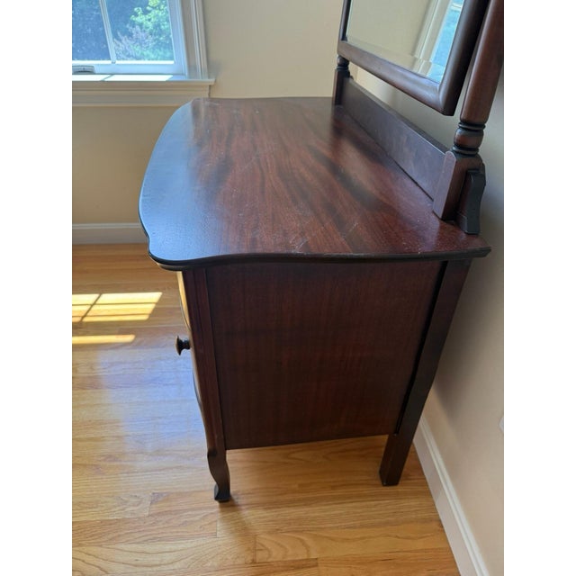 Elevate your bedroom or dressing area with this classic two-piece antique Victorian-style vanity chest and mirror set....