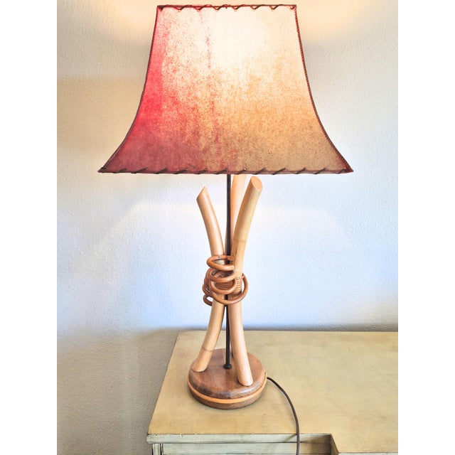 Large, working vintage 1940's rattan lamp with whipstitch rawhide shade. Lamp and shape are in excellent condition. Shade...