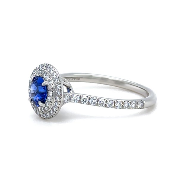A timeless Tiffany & Co. Soleste engagement ring crafted in platinum, featuring a vivid royal blue sapphire centre stone...