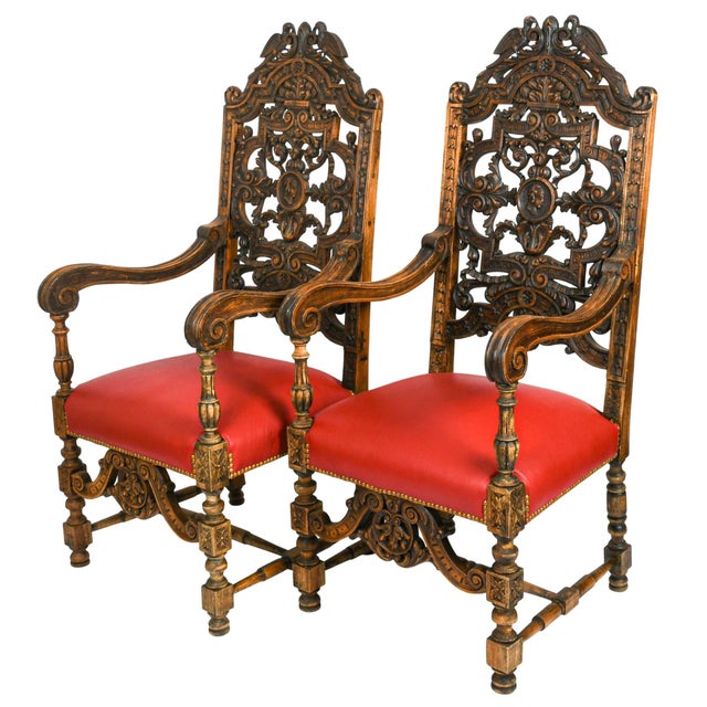 This antique pair of carved walnut throne chairs makes a striking statement with their commanding scale, elaborate...