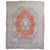 An authentic Persian Sarouk rug with a classic blue center medallion on an open field with a camel border. Accents of soft...
