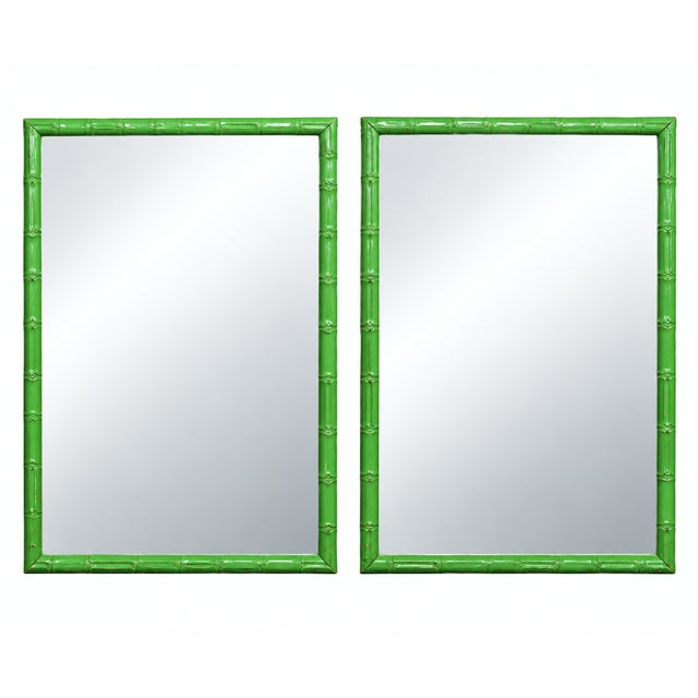 A pair of rectangular wall mirrors in glossy green painted frames molded as faux bamboo, each fitted with a beveled mirror...