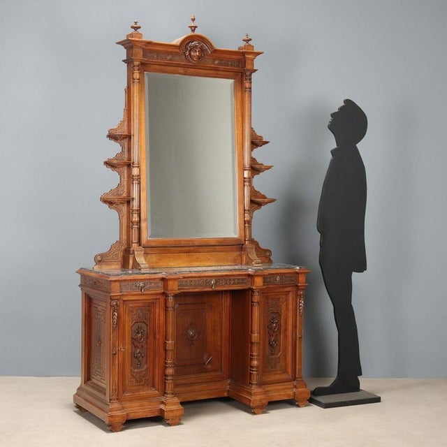 Open walnut Umbertina dressing table. Tilting beveled mirror with carved rear panel, supported by turned half-columns...