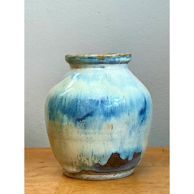 This vintage pottery vase is a small, painterly piece of studio ceramics, with a full, rounded body that swells at the...