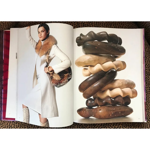 Scarce hardcover Escada catalogue from 2003 brings you 172 pages of high fashion from the famed luxury clothing company...