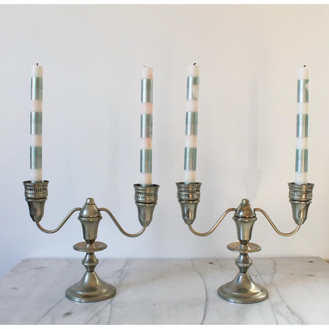 Pair of two-arm silver tone candelabras by Shrewsbury Holloware. Can also separate into single taper candle holders....