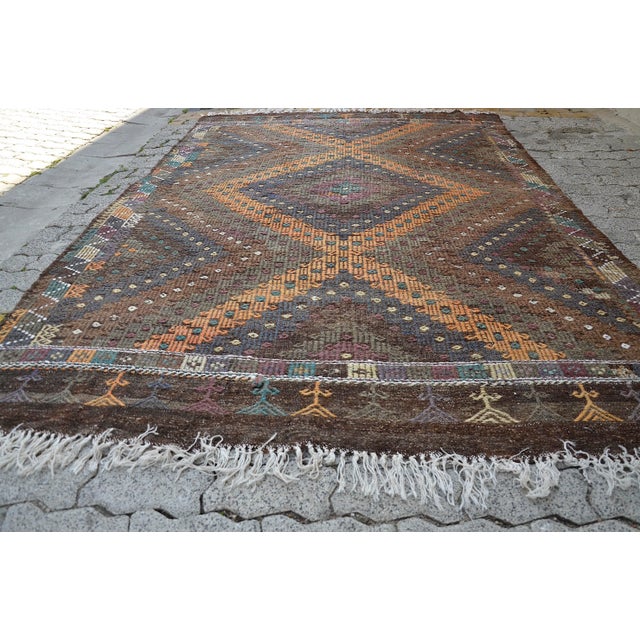 This is a vintage Turkish Anatolian kilim rug from the 1960s. The piece was hand-woven.