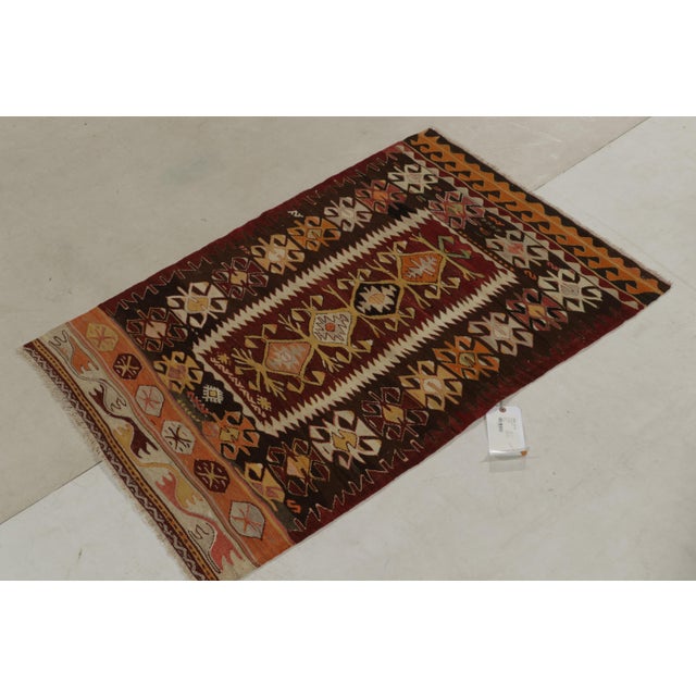 Handwoven in wool circa 1940-1950l, this 3x5 vintage Kilim from the Konya region of Turkey showcases an interesting...