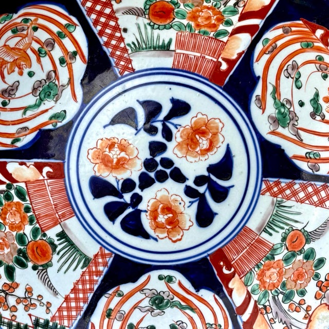 This large antique Japanese porcelain charger is an example of Arita ware made in the Imari style, measuring over 13...