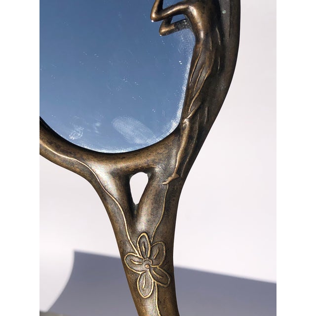 French Art Deco Brass Handheld Mirror with Female Figure and Flower Etchings A small French art deco 1920s handheld brass...