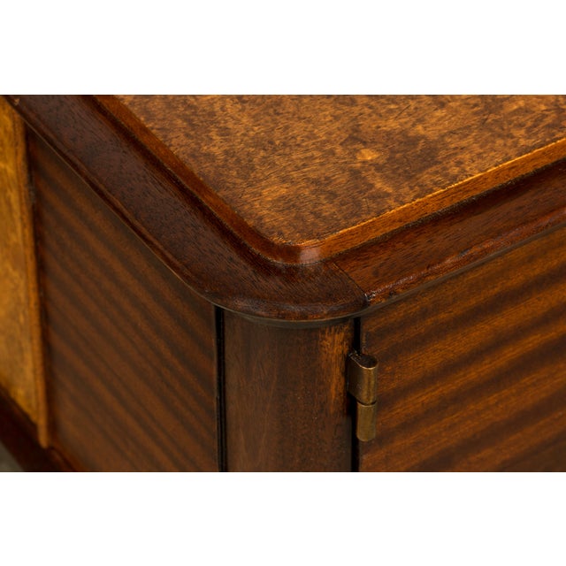 Elegant pair of French Art Deco nightstands dating to the 1930s, sourced in Provence, France. Crafted in mahogany with...