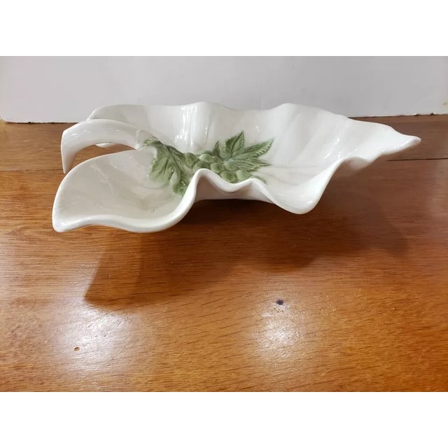 This is a Vintage Hull Platter Leaf Shaped Bowl with Grapes Motif. It measures 3 3/8" high at highest point, 13 1/2" long...