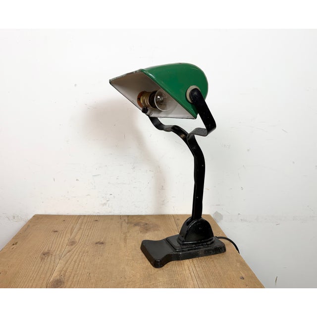 Vintage bankers bauhaus table lamp made in Germany during the 1930s. It features a green enamel iron shade with white...