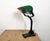 Vintage bankers bauhaus table lamp made in Germany during the 1930s. It features a green enamel iron shade with white...