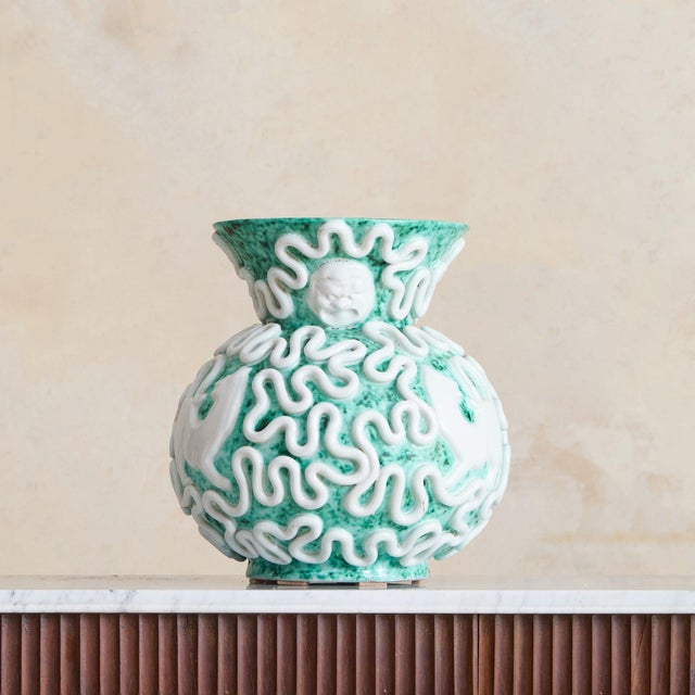 A French ceramic vase from the 1950s by Gustave Asch, where surface and texture take precedent. The glaze, a mottled...