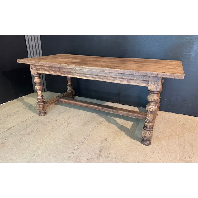 A solid Oak Farmhouse Dining Table having loads of character to the wood and a rare 2 plank top. Turned leg supports and...