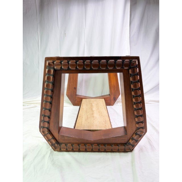 This extraordinary 70's Brutalist coffee table which appears to be crafted from solid walnut is defined by a highly...