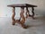 A table in solid walnut, with the edge beneath the top carved, and lyre-shaped legs joined by curved wooden spandrels....