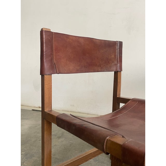 Pair of chairs attributed to Paco Muñoz, carved oak with hazelnut colored leather. Spain, 1960s. Original vintage piece...