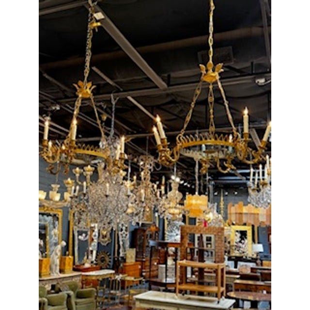 The product is a pair of fine 19th-century Baltic gilt bronze neoclassical chandeliers. These stunning chandeliers feature...