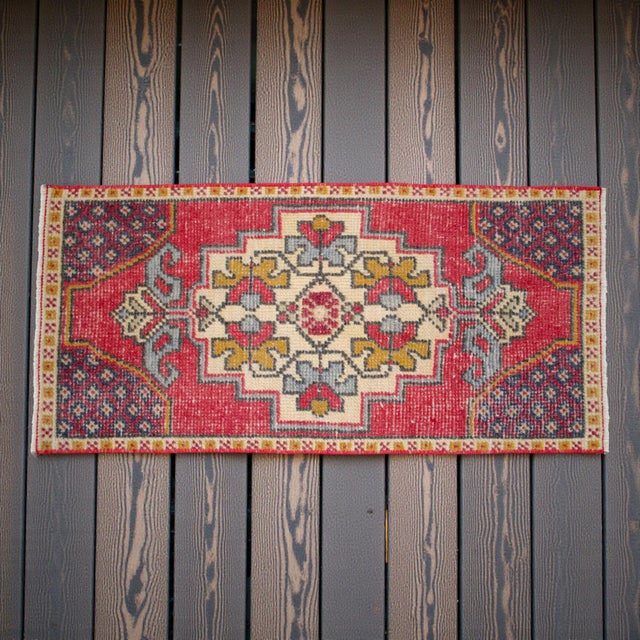 This charming hand-knotted small rug showcases a vibrant yet softly aged aesthetic, perfect for adding a touch of soulful...