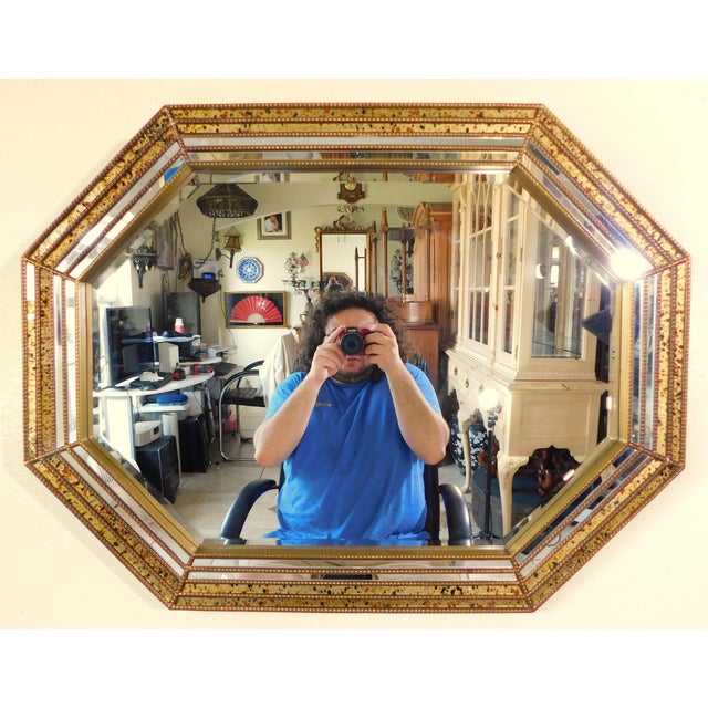 Wonderful vintage mid-century modern gold spotted glass hanging wall mirror. Great piece! Circa 1970s. Made in the USA....