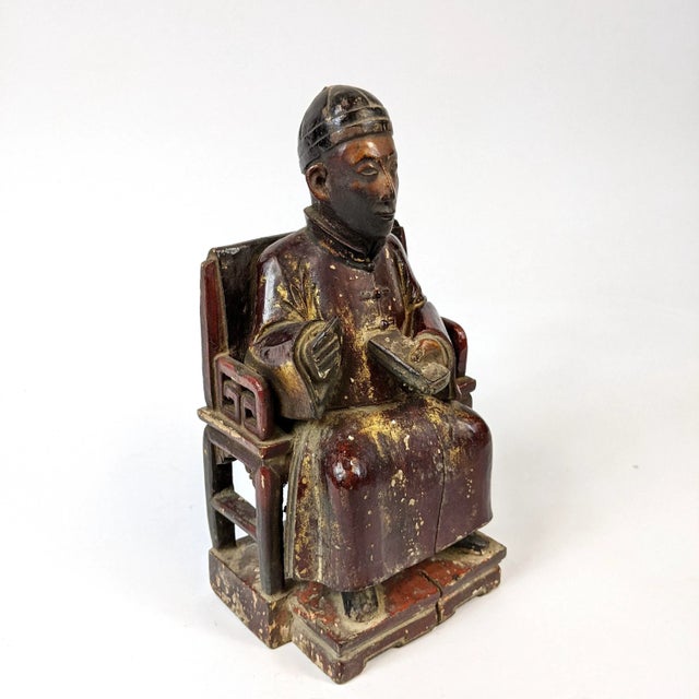 This wooden carving of a scholar is from the Qing Dynasty.