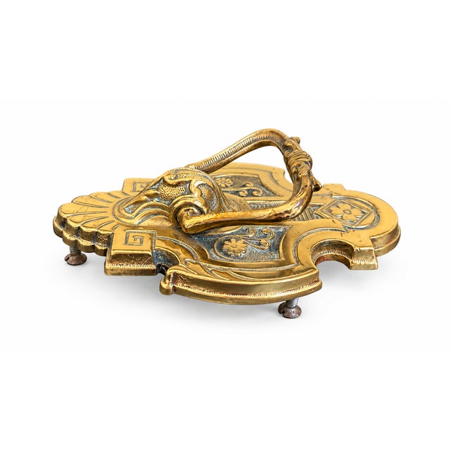 Make a striking first impression with this beautifully detailed vintage brass door knocker, featuring an elaborate...