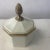 Adorable ceramic box by modernist Ernest Sohn features a white ceramic design with gold leaf and crest. Signed on back.