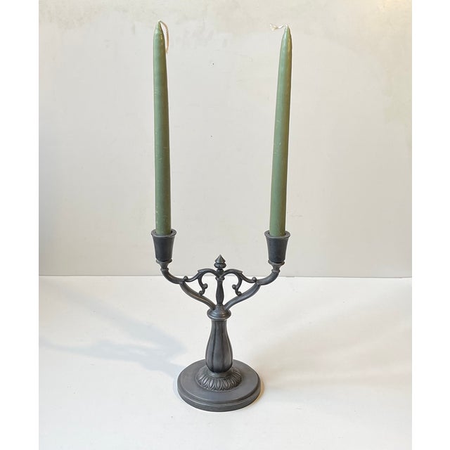 A stylish candelabra in pewter designed by just andersen. Manufactured during the 1930s in his workshop in copenhagen....