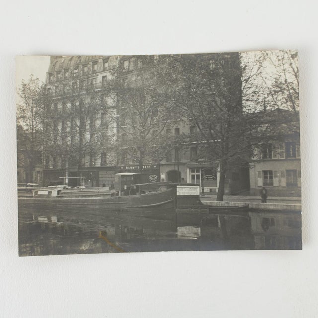 An authentic original silver gelatin black-and-white photograph capturing a timeless view of the Canal Saint-Martin at 82...