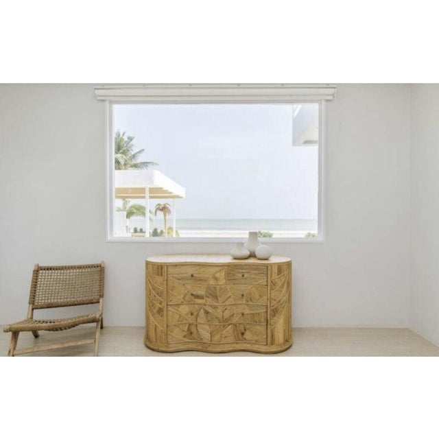 Amazing 4 drawers rattan curved chest with « foliages » patterns, raffia top and brass handles. Unique design inspired by...