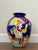 A vibrant vintage Italian ceramic floor vase by La Musa, featuring bold hand-painted folk art scenes in saturated cobalt...